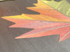 Short video panning over an in-process Autumn Maple Leaf wall art, highlighting the hand-stained gradient colors during production.